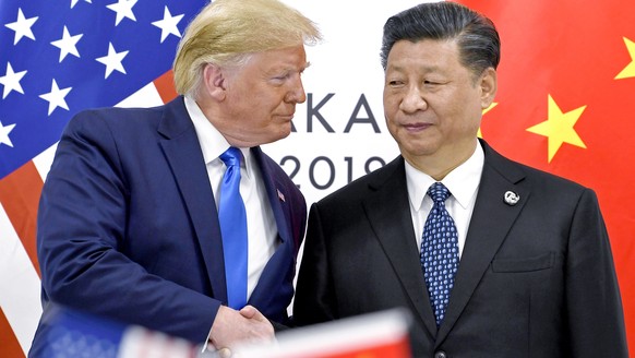 FILE - President Donald Trump, left, shakes hands with China&#039;s President Xi Jinping during a meeting on the sidelines of the G-20 summit in Osaka, Japan, June 29, 2019. (AP Photo/Susan Walsh, Fil ...
