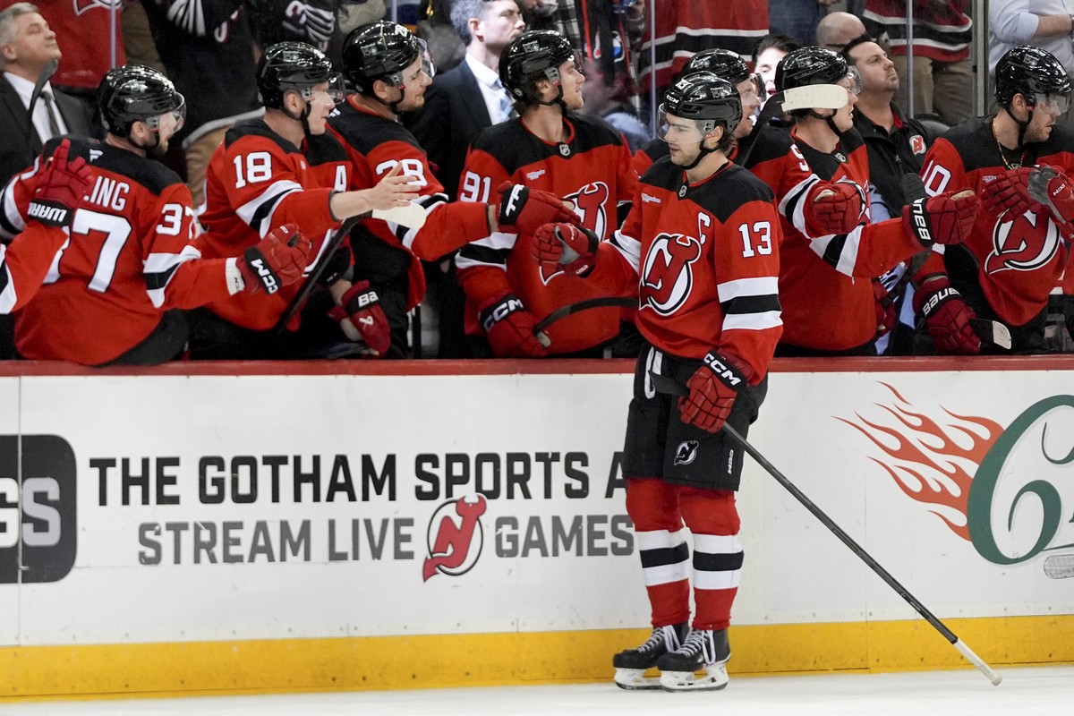 New Jersey Devils center Nico Hischier (13) celebrates his goal with teammates during the third period of an NHL hockey game against the Minnesota Wild, Monday, March 31, 2025, in Newark, N.J. (AP Pho ...