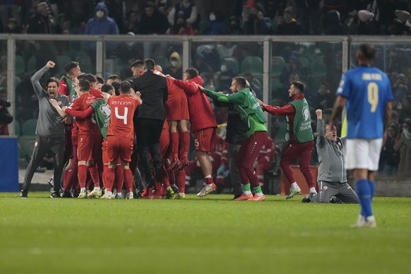 North Macedonia players celebrate at the end of the World Cup qualifying play-off soccer match between Italy and North Macedonia, at Renzo Barbera stadium, in Palermo, Italy, Thursday, March 24, 2022. ...