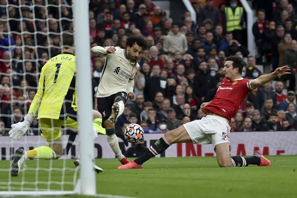 Liverpool&#039;s Mohamed Salah attempts a shot at goal as Manchester United&#039;s Harry Maguire, right, tries to block him during the English Premier League soccer match between Manchester United and ...