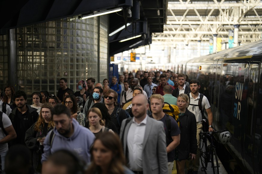 Passengers disembark from one of the few trains to arrive this morning at Waterloo railway station in London, Tuesday, June 21, 2022. Britain is facing its biggest rail strikes in decades after last-m ...