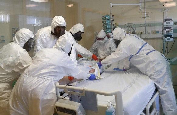 Health care workers transport a COVID-19 patient from an intensive care unit (ICU) at hospital in Kyjov to a hospital in Brno, Czech Republic, Thursday, Oct. 22, 2020. With cases surging in central Eu ...
