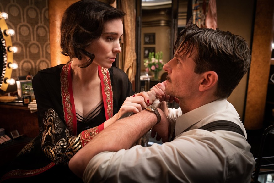 This image released by Searchlight Pictures shows Rooney Mara, left, and Bradley Cooper in a scene from &quot;Nightmare Alley.&quot; (Searchlight Pictures via AP)