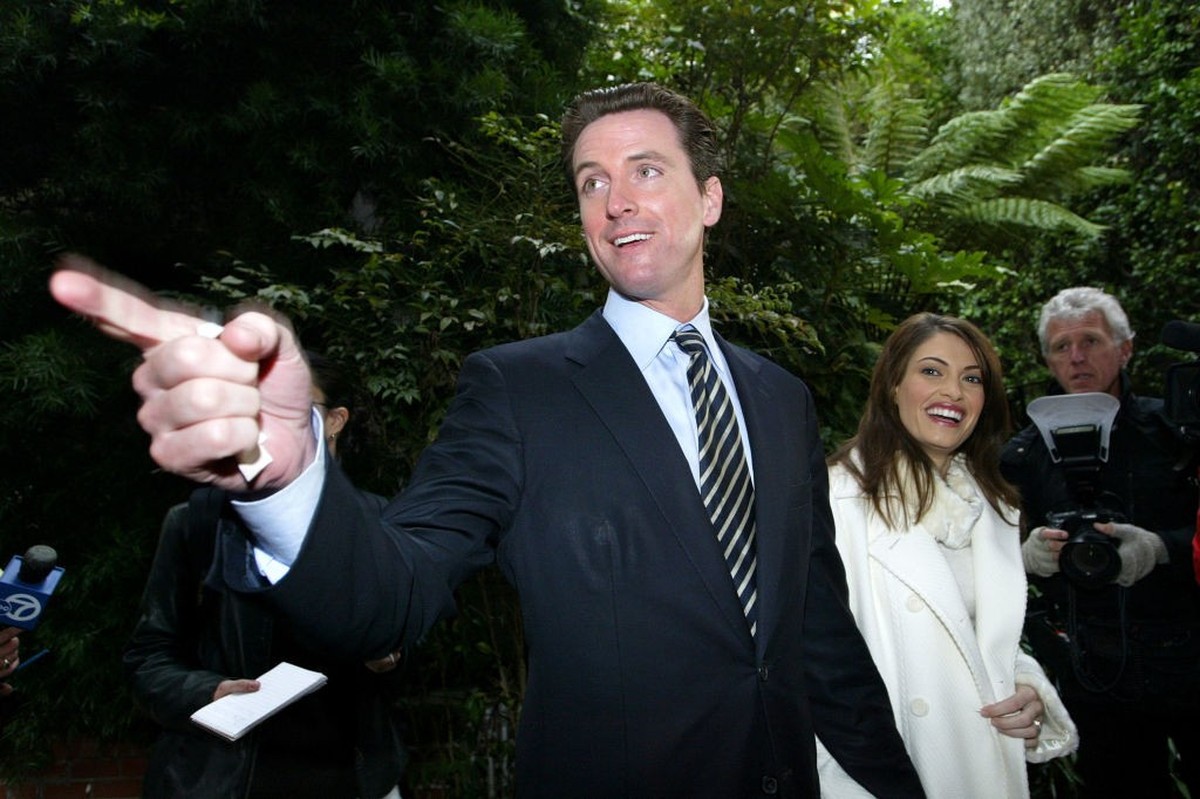 SAN FRANCISCO - DECEMBER 9 : San Francisco mayoral candidate Gavin Newsom (L) and his wife Kimberly Guilfoyle-Newsom leave a polling place after they cast their ballots for the mayoral run-off electio ...