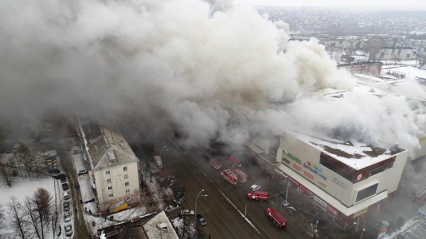 In this Russian Emergency Situations Ministry photo, on Sunday, March 25, 2018, smoke rises above a multi-story shopping center in the Siberian city of Kemerovo, about 3,000 kilometers (1,900 miles) e ...