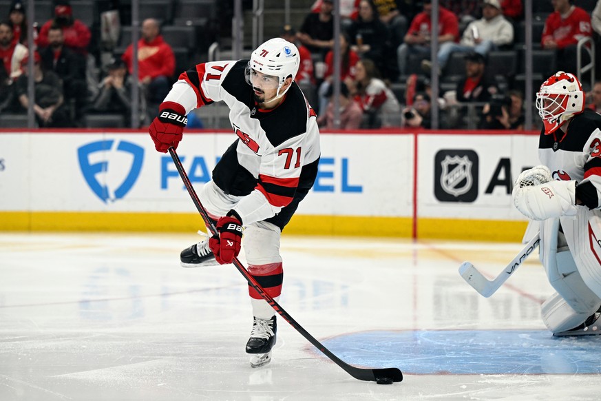 New Jersey Devils defenseman Jonas Siegenthaler passes the puck during the second period of an NHL hockey game against the Detroit Red Wings, Saturday, April 11, 2026, in Detroit. (AP Photo/Jose Juare ...