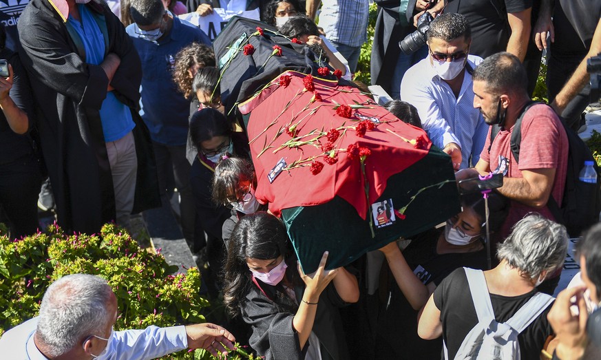 People carry the coffin of Ebru Timtik, a human rights lawyer who died during a hunger strike in a Turkish prison to demand a fair trial for herself and colleagues, in Istanbul, Friday, Aug. 28, 2020. ...