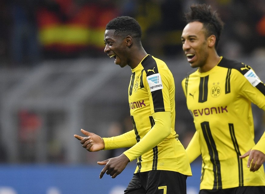 FILE - In this Feb. 18, 2017 file photo Borussia Dortmund&#039;s Ousmane Dembele of France, left, celebrates beside teammate Pierre-Emerick Aubameyang during the Bundesliga soccer match against VfL Wo ...