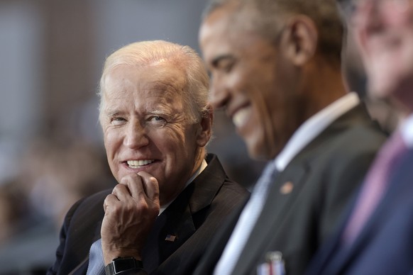 FILE - In this Jan. 4, 2017 file photo, Vice President Joe Biden, left, watches President Barack Obama, center, at Conmy Hall, Joint Base Myer-Henderson Hall, Va. Democrats hoping to create a surge of ...