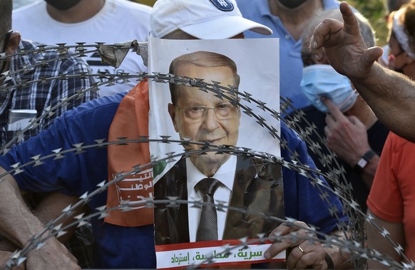 epa08664876 Supporters of Lebanese President Michel Aoun shout slogans as they gather before the arrival of the anti-government protesters near the presidential palace in Baabda, east Beirut, Lebanon, ...