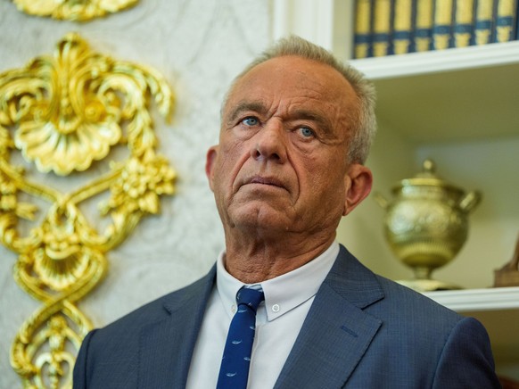 epa12601502 United States Secretary of Health and Human Services Robert F Kennedy Jr is seen as US President Donald J Trump signs an executive order to reschedule marijuana from Schedule I to Schedule ...