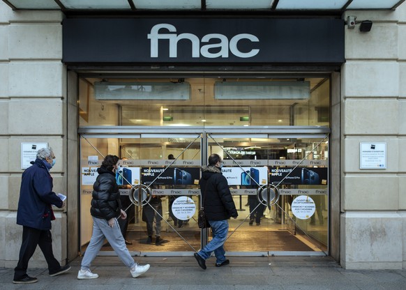 People enter a Fnac multimedia store, which remains open despite the lockdown in Paris, Friday, Oct. 30, 2020. France re-imposed a monthlong nationwide lockdown Friday aimed at slowing the spread of t ...