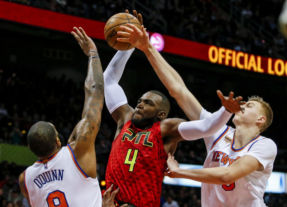 Jan 29, 2017; Atlanta, GA, USA; Atlanta Hawks forward Paul Millsap (4) is fouled by New York Knicks forward Kristaps Porzingis (6) as he tries to dunk the ball over Knicks center Kyle O'Quinn (9) ...