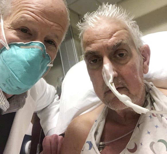 In this photo provided by the University of Maryland School of Medicine, Dr. Bartley Griffith takes a selfie photo with patient David Bennett in Baltimore in January 2022. In a medical first, doctors  ...