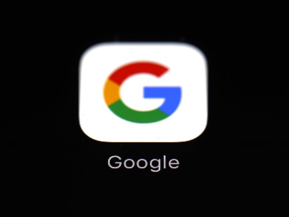 FILE - This March 19, 2018 file photo shows a Google app in Baltimore. Google says Apple has also revoked its access to a key developer tool, preventing its employees from testing new app features on  ...