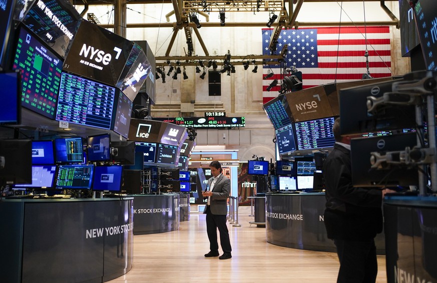 FILE - Traders work on the floor at the New York Stock Exchange in New York, Aug. 10, 2022. Stocks slipped in morning trading on Wall Street Wednesday, Oct. 26, 2022 and big technology stocks were the ...