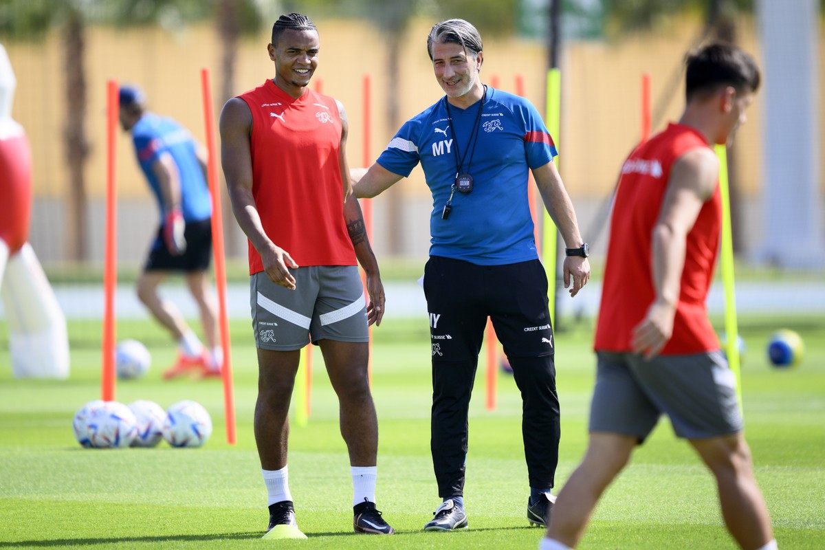 epa10312488 Switzerland's head coach Murat Yakin (C) and Manuel Akanji (L) attend their team's training session in preparation for the FIFA World Cup 2022 at the University of Doha for Scien ...