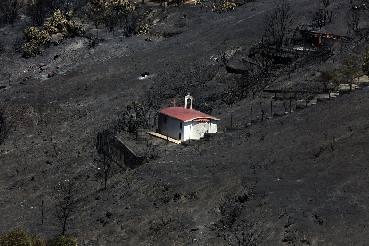 epa12290948 A small curch in the middle of burned land after a wildfire in the area of Keratea, Southeast Attica, Greece, 09 August 2025. Major and destructive wildfires that began on 08 August in Ker ...