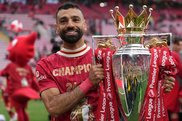 FILE - Liverpool's Mohamed Salah poses with the winner's trophy after the English Premier League soccer match between Liverpool and Crystal Palace at the Anfield stadium in Liverpool, Englan ...