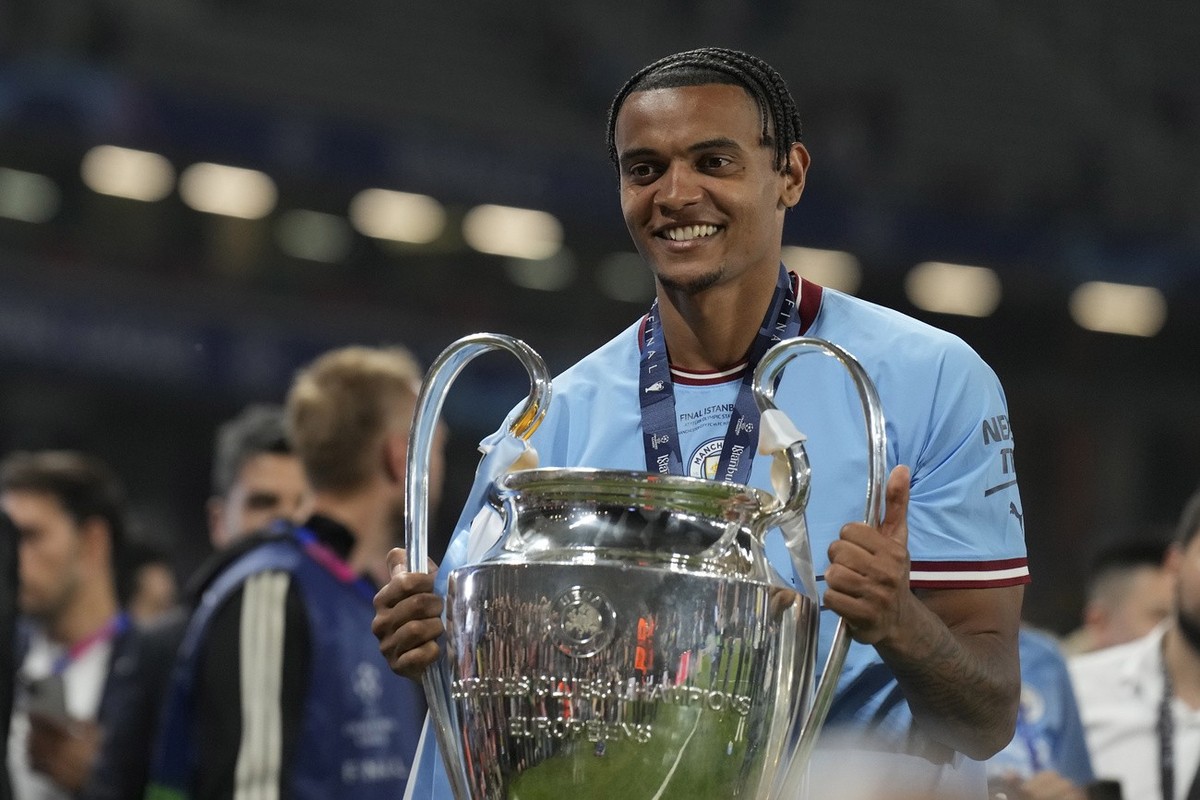 Manchester City's Manuel Akanji celebrates with the trophy after winning the Champions League final soccer match between Manchester City and Inter Milan at the Ataturk Olympic Stadium in Istanbul ...