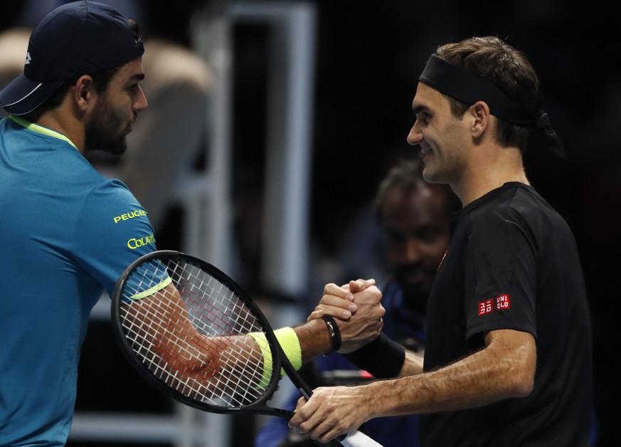 Switzerland&#039;s Roger Federer, right, shakes hands with Italy&#039;s Matteo Berrettini after defeating him in their their ATP World Tour Finals singles tennis match at the O2 Arena in London, Tuesd ...