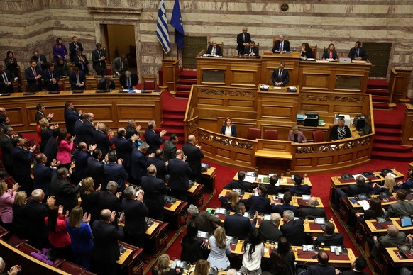 epa11248678 Greek Prime Minister Kyriakos Mitsotakis is applauded by his MPs during the debate on the no-confidence motion against the government at a session of the Parliament in Athens, Greece, 28 M ...