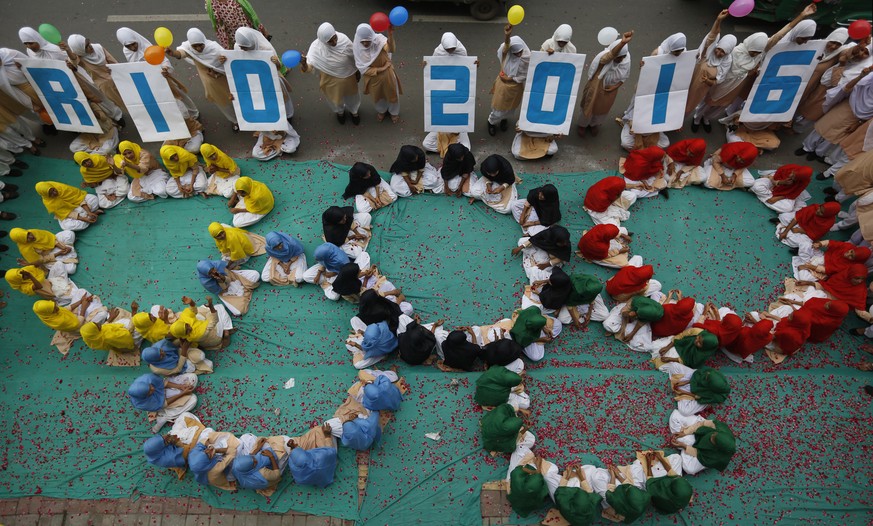 Indian school children make a formation of the iconic Olympic rings to wish Indian players good luck ahead of the Olympic games, near a school in Ahmadabad, India, Wednesday, Aug. 3, 2016. The summer  ...