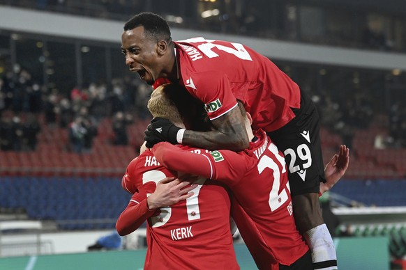 Hannover's Gael Ondoua, top, celebrates with teammates after scoring his side's third goal of the game during the German Cup round of 16 soccer match between Hannover 96 and Borussia Moenchengladbach at the HDI Arena in Hanover, Germany, Wednesday, Jan. 19, 2022. (Swen Pfortner/dpa via AP)