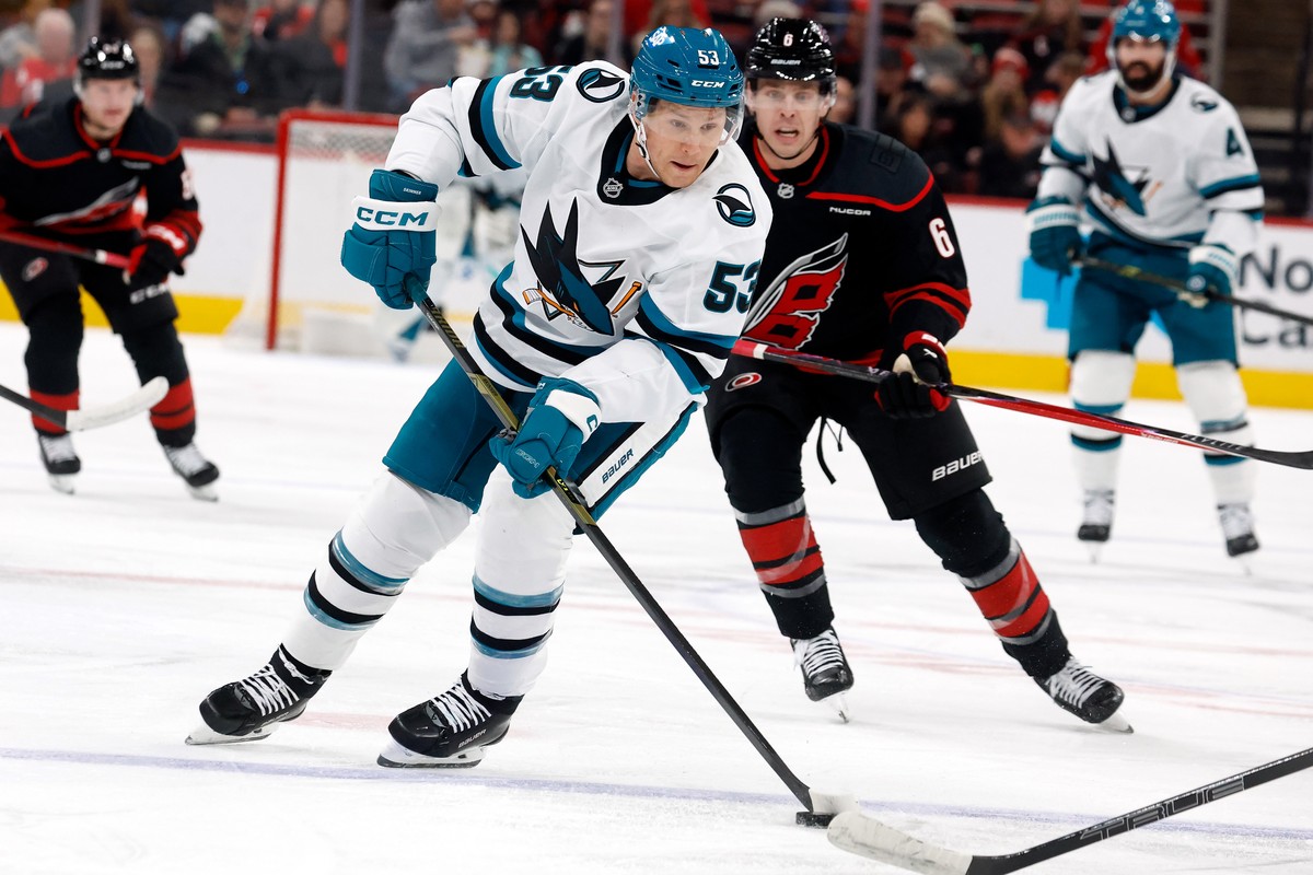 San Jose Sharks' Jeff Skinner (53) skates the puck away from Carolina Hurricanes' Mike Reilly (6) during the first period of an NHL hockey game in Raleigh, N.C., Sunday, Dec. 7, 2025. (AP Ph ...