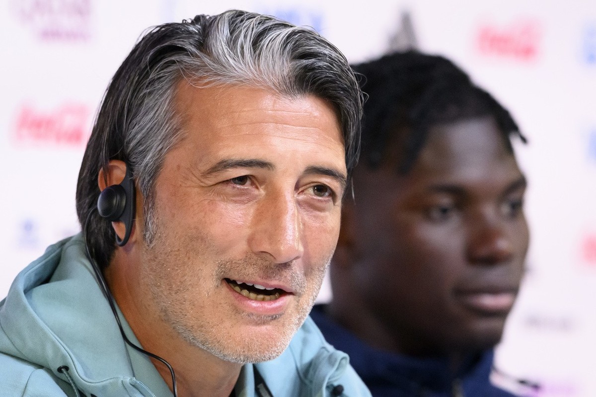 Switzerland's head coach Murat Yakin, left, and Switzerland's forward Breel Embolo, right, during a press conference of the Swiss national soccer team on the eve of their FIFA World Cup 2022 ...