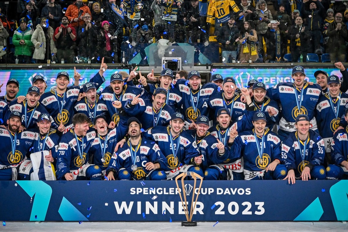 Davos' team celebrate with the trophy after winning the final game between Switzerland's HC Davos and HC Dynamo Pardubice, at the 95th Spengler Cup ice hockey tournament in Davos, Switzerlan ...