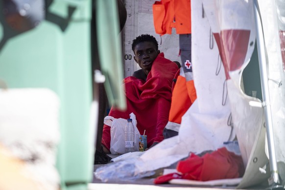 epa10949052 A migrant is assisted following the arrival of a group of migrants to the port of Los Cristianos in Tenerife, Canary Islands, Spain, 30 October 2023. A total of 213 migrants were rescued a ...