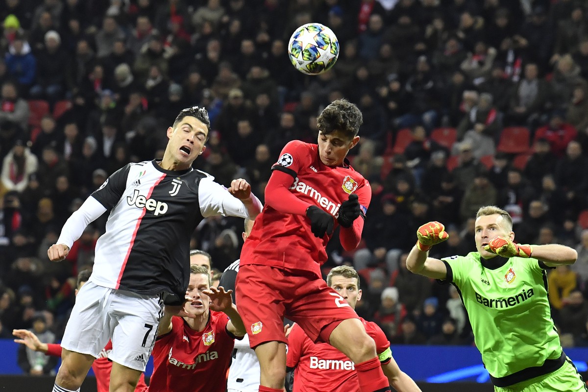 Leverkusen's Kai Havertz, center, heads the ball past Juventus' Cristiano Ronaldo during the Champions League Group D soccer match between Bayer Leverkusen and Juventus at the BayArena in Le ...