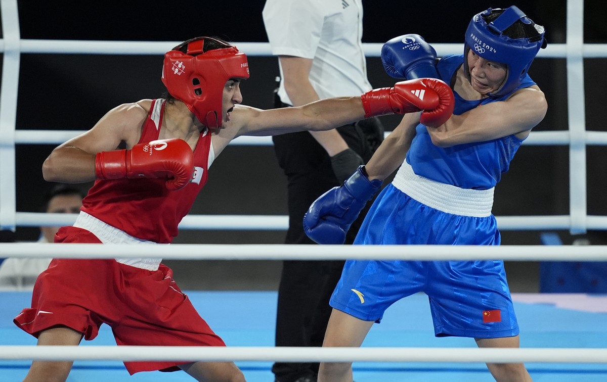 Algeria's Imane Khelif, left, fights China's Yang Liu in their women's 66 kg final boxing match at the 2024 Summer Olympics, Friday, Aug. 9, 2024, in Paris, France. (AP Photo/John Loche ...