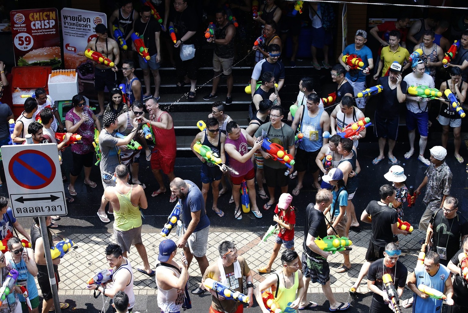 epa05256483 Thai and tourists play with water as they join the annual Songkran Festival celebration, the Thai traditional New Year, also known as the water festival, in Silom district of Bangkok, Thai ...