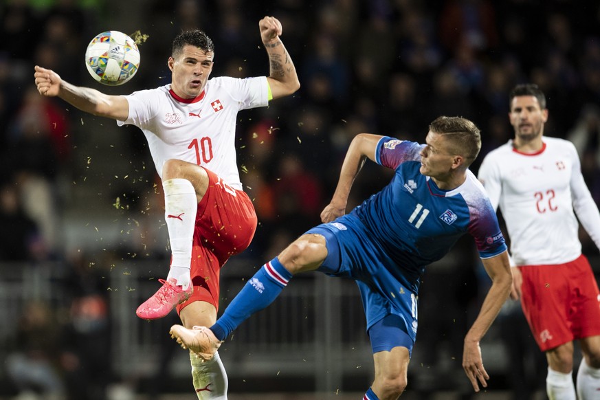 Switzerland&#039;s Granit Xhaka left, fights for the ball against Iceland&#039;s Alfred Finnbogason, right, during the UEFA Nations League soccer match between Iceland and Switzerland at the Laugardal ...