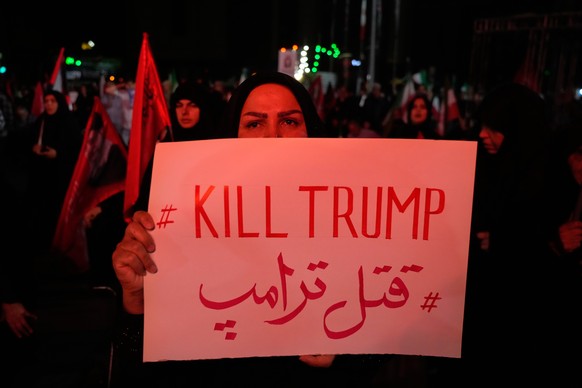 A pro-government demonstrator holds an anti-Trump placard in a gathering commemorating the late Iranian Supreme Leader Ayatollah Ali Khamenei at a square in Tehran, Saturday, July 11, 2026. (AP Photo/ ...