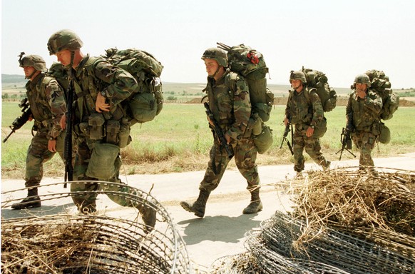 Soldiers of the US 82nd Airborne Division arrive at Skopje airport near the town of Petrovac, Macedonia, Thursday June 10, 1999. NATO troops are getting ready in Macedonia to enter Kosovo, after a mil ...