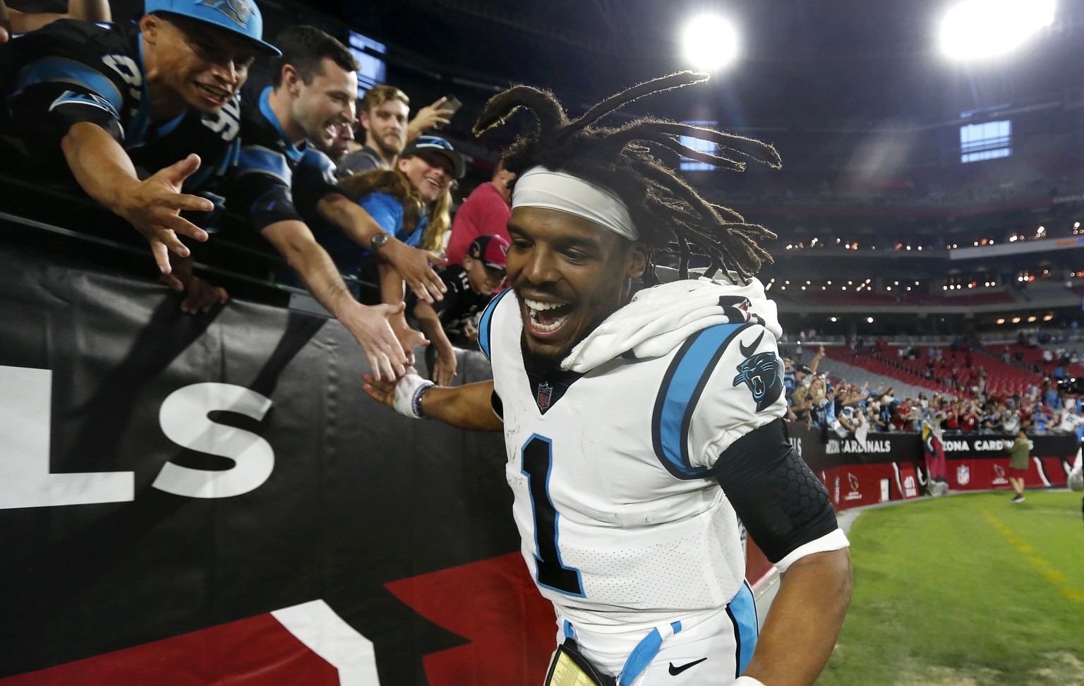 Carolina Panthers quarterback Cam Newton celebrates with Panthers fans after an NFL football game against the Arizona Cardinals Sunday, Nov. 14, 2021, in Glendale, Ariz. The Panthers defeated the Card ...