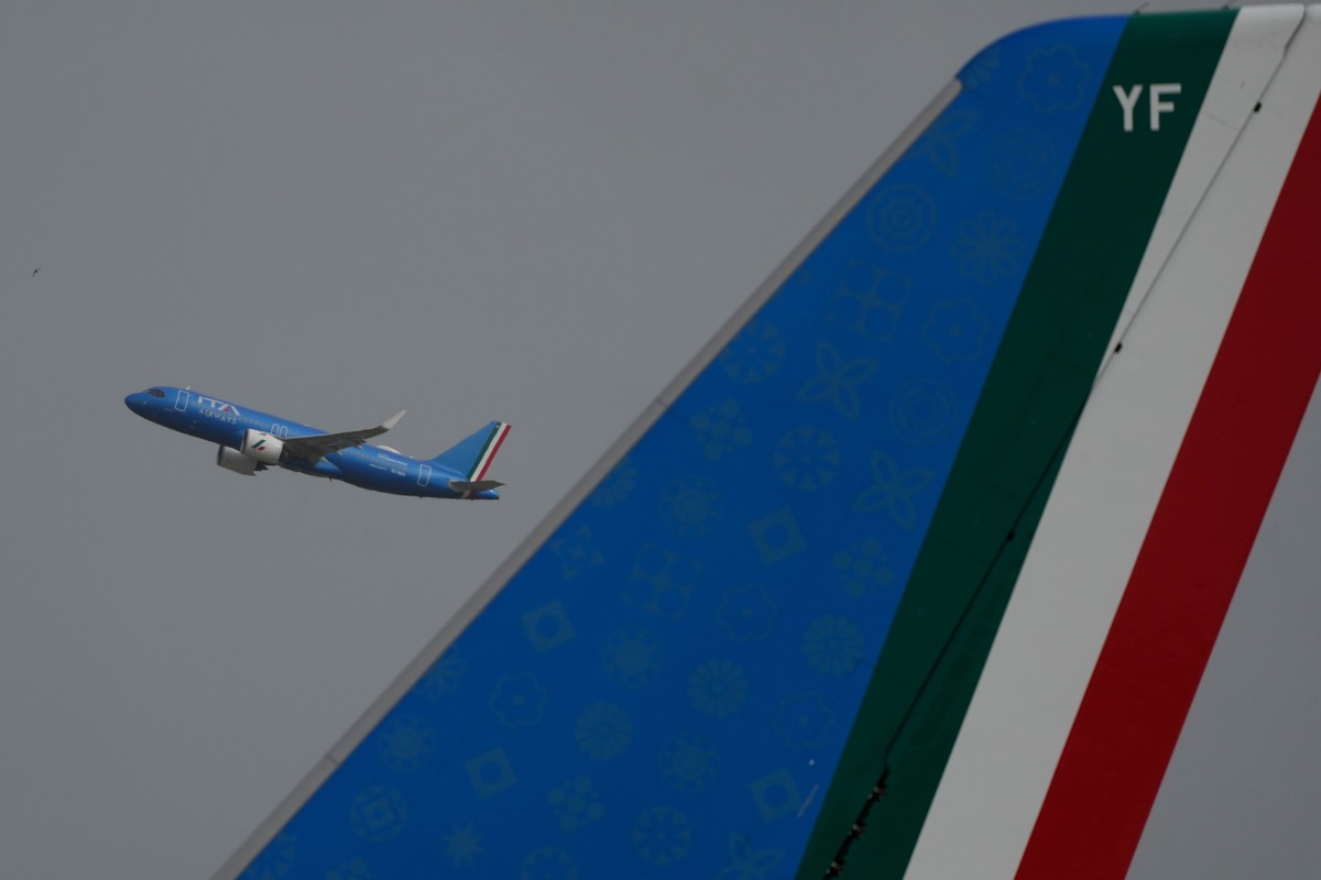 The tail of the plane carrying Pope Leo XIV to Algiers, right, is seen against the backdrop of an ITA Airways flight taking off from Romes Leonardo da Vinci-Fiumicino International Airport on Monday, ...