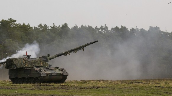 A Bundeswehr self-propelled howitzer 2000 (PzH 2000 for short) fires at the training area during the &quot;Wettiner Heide&quot; exercise maneuvers of the German army Bundeswehr in Munster, Germany, Tuesday, May 10, 2022. The exercise, involving up to 7,500 soldiers from nine nations, is taking place at the heart of the Bergen and Munster military training areas in Lower Saxony. (Philipp Schulze/dpa via AP)
