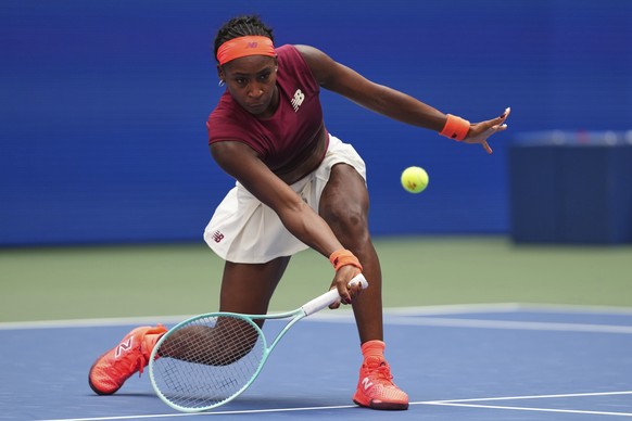Coco Gauff, of the United States, returns a shot against Naomi Osaka, of Japan, during the fourth round of the US Open tennis championships, Monday, Sept. 1, 2025, in New York. (AP Photo/Kirsty Wiggle ...