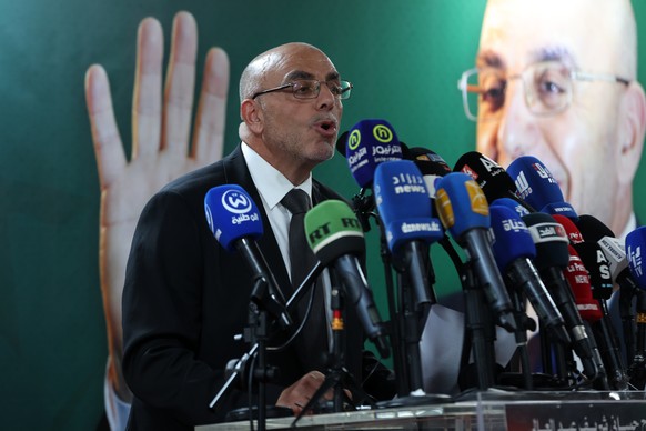epa11594392 Presidential candidate of the Movement of Society for Peace (MSP), Abdelali Hassani Cherif, speaks during press conference a day after the Algerian presidential elections in Algiers, Alger ...