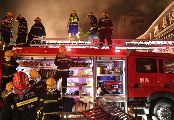 epa10705057 Firefighters at work at the scene of an explosion in Yinchuan, China's Ningxia Hui Autonomous Region, June 21, 2023. The death toll from an explosion caused by a barbecue restaurant...