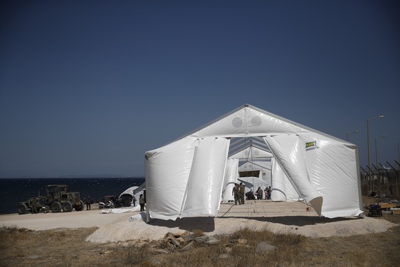 epa08668478 Greek soldiers construct a tent in a new camp near Kara Tepe, Mytilene, Greece, Greece, 14 September 2020. A fire broke out in the overcrowded Moria Refugee Camp early 09 September 2020, d ...