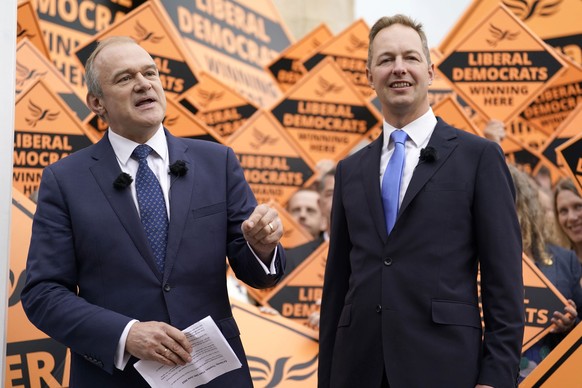 Liberal Democrat Leader Ed Davey, left, celebrates with Richard Foord, right, the newly-elected Liberal Democrat lawmaker for Tiverton and Honiton, in Crediton, England, Friday June 24, 2022. British  ...