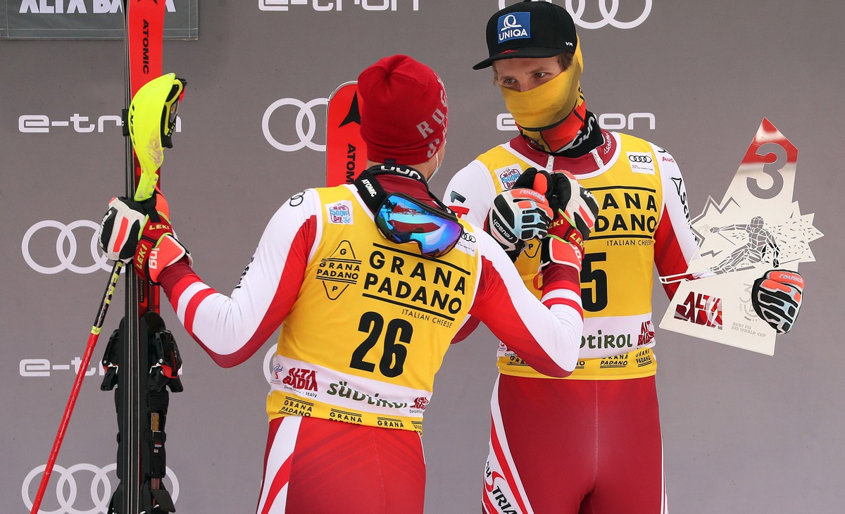 epa08897853 Second placed Manuel Feller (L) of Austria and his teammate, third placed Marco Schwarz celebrate on the podium for the Men's Slalom race at the FIS Alpine Skiing World Cup in Alta Ba ...