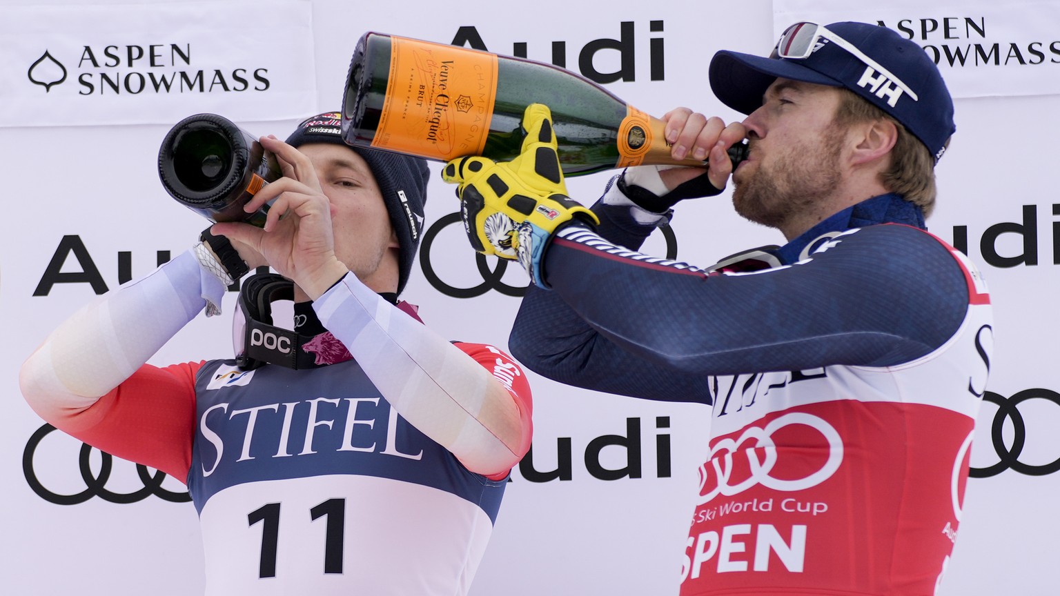 Norway&#039;s Aleksander Aamodt Kilde, right, drinks champagne on the podium with Canada&#039;s James Crawford, left, and Switzerland&#039;s Marco Odermatt, center, after winning the men&#039;s World  ...