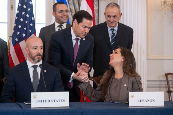 Secretary of State Marco Rubio shakes hands with Lebanon's Ambassador to the U.S. Nada Hamadeh, left, following a signing of a framework agreement, described as a first step toward peace followin ...