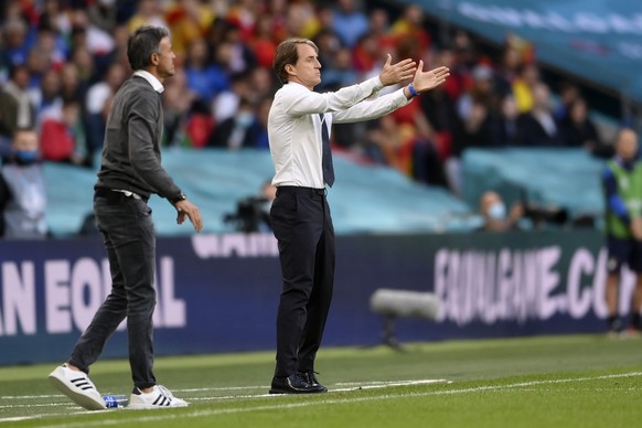 Spain&#039;s manager Luis Enrique, left, and Italy&#039;s manager Roberto Mancini give instructions during the Euro 2020 soccer semifinal match between Italy and Spain at Wembley stadium in London, Tu ...